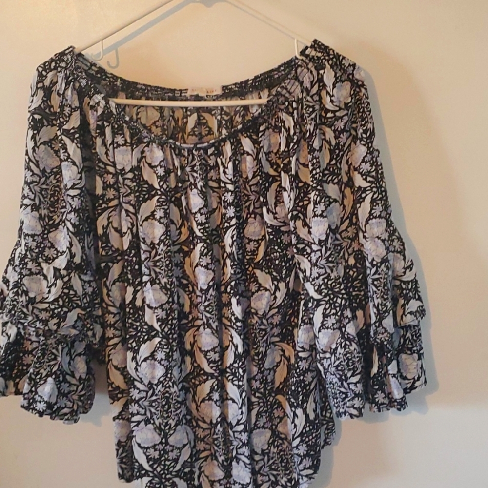 Off the shoulder neckline and double bell sleeve make this top oh so feminine